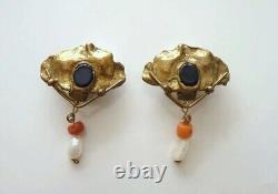 Exceptional vintage Art Nouveau clips in brass, coral, and onyx.